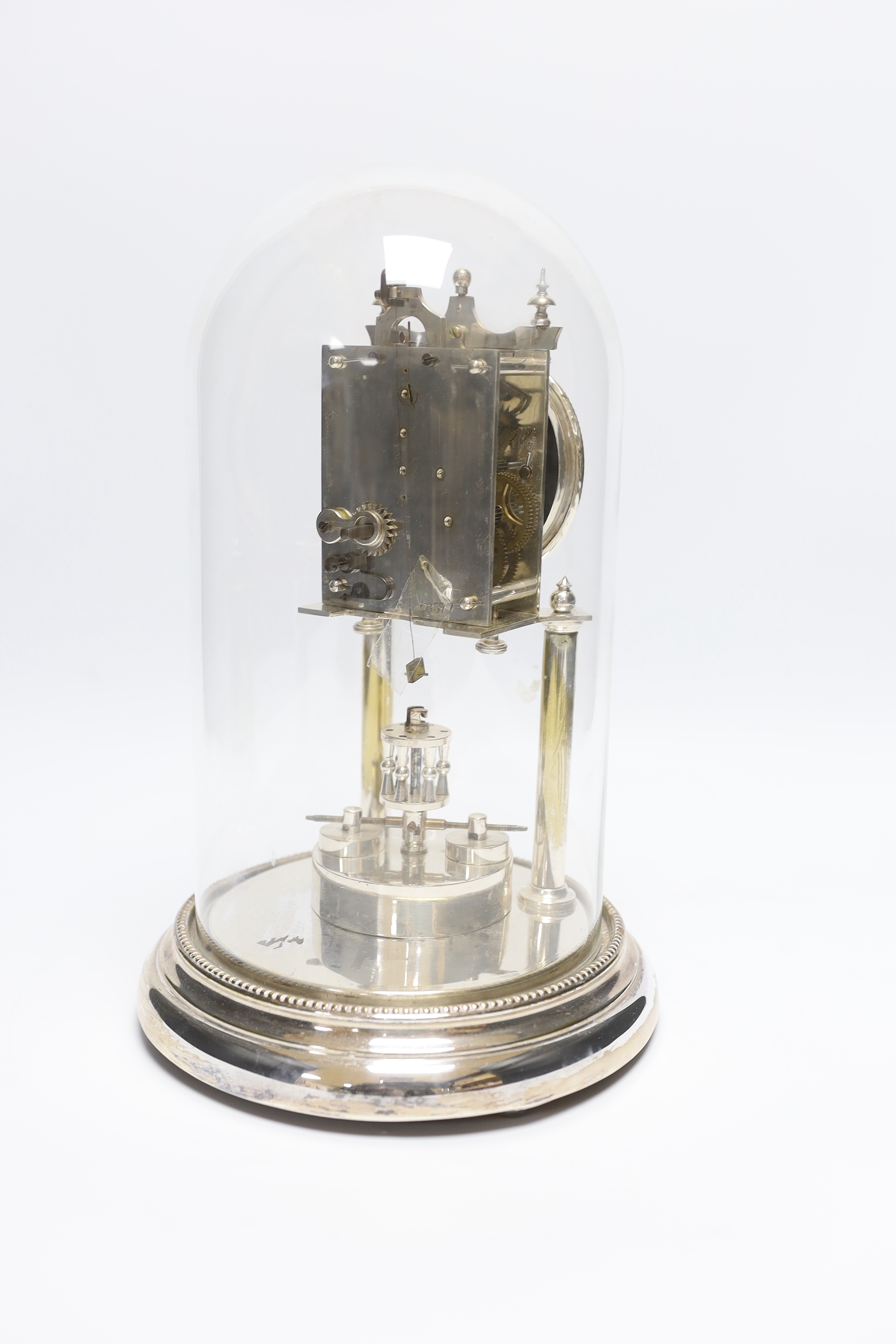 A chrome plated skeleton clock under dome, 29cm